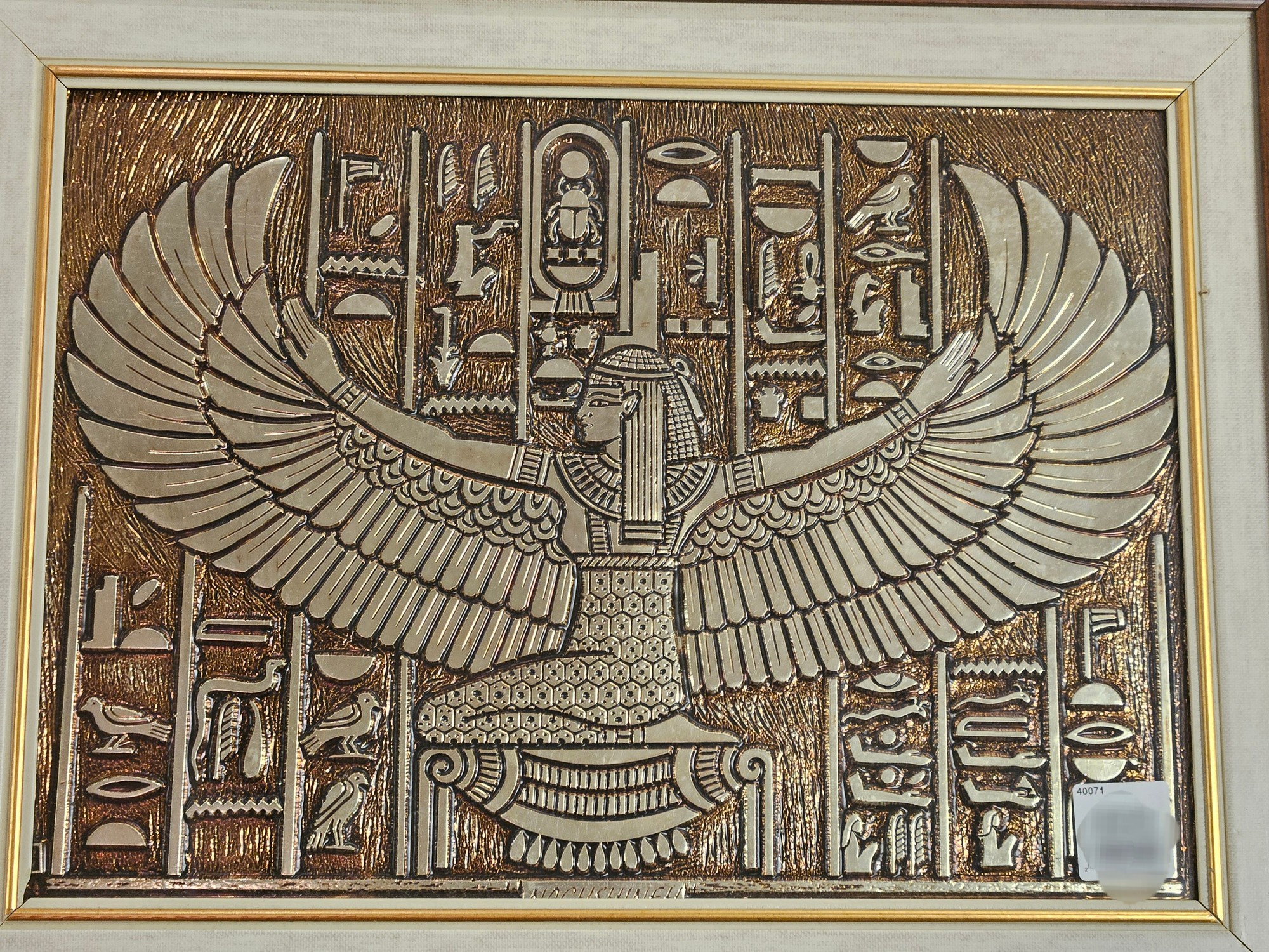 A picture depicting ancient Egyptian hieroglyphs and a person with bird wings.